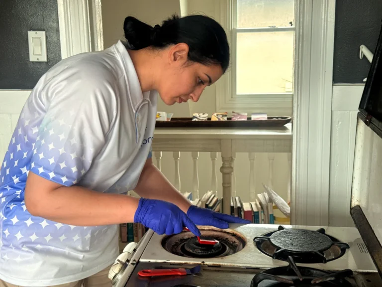 Sygora cleaner scrubbing a stove burner.